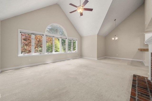 unfurnished living room with carpet, baseboards, lofted ceiling, and ceiling fan with notable chandelier