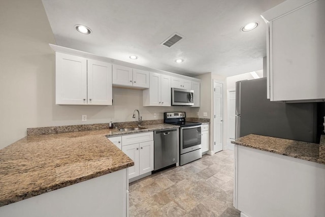 kitchen with white cabinetry, stainless steel appliances, and a sink