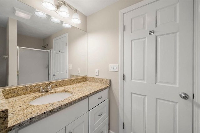 bathroom featuring vanity and a shower stall