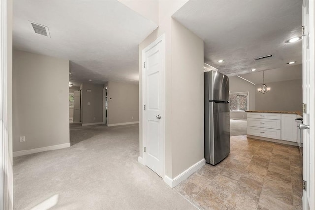 hall featuring baseboards, recessed lighting, and visible vents