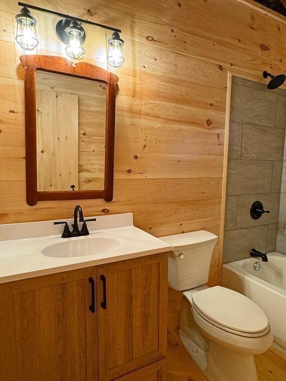 14 Wood Way, Northfield, MA 01360 - bathroom featuring toilet, vanity, wood walls, and tub / shower combination