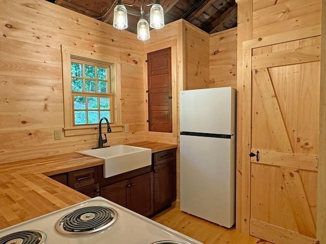 14 Wood Way, Northfield, MA 01360 - kitchen featuring freestanding refrigerator, wooden counters, a sink, light wood-style floors, and wood walls