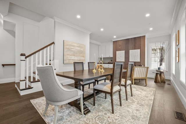 dining room with ornamental molding, recessed lighting, wood finished floors, and visible vents