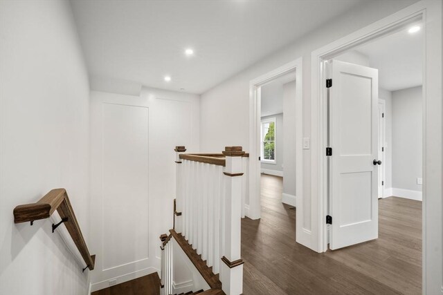 hall with recessed lighting, baseboards, an upstairs landing, and wood finished floors