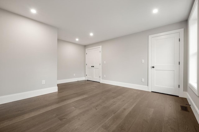 spare room featuring recessed lighting, baseboards, visible vents, and wood finished floors