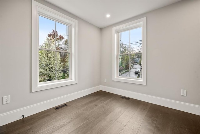 interior space featuring baseboards, visible vents, and a healthy amount of sunlight