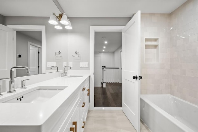full bathroom with a sink, washtub / shower combination, and double vanity
