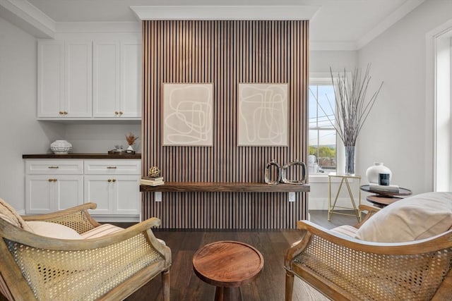 living area featuring radiator heating unit, ornamental molding, and wood finished floors