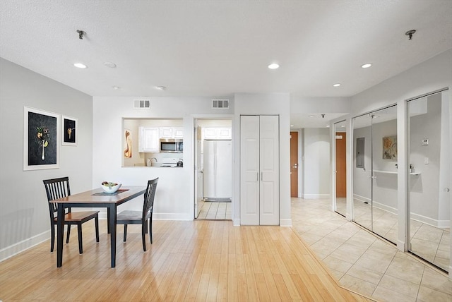 dining room with light hardwood / wood-style floors