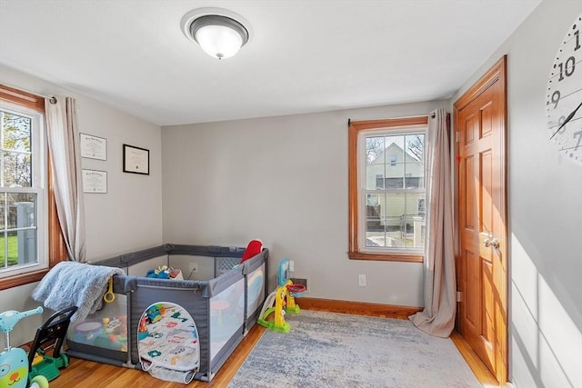 bedroom featuring wood finished floors, visible vents, and baseboards