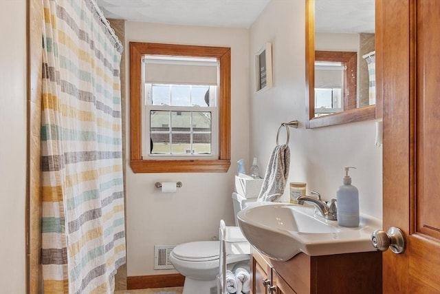 bathroom featuring visible vents, toilet, a shower with curtain, and vanity