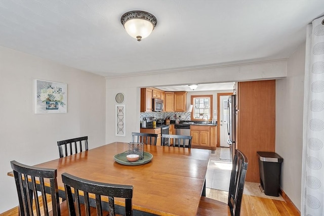 dining area featuring light wood-style floors