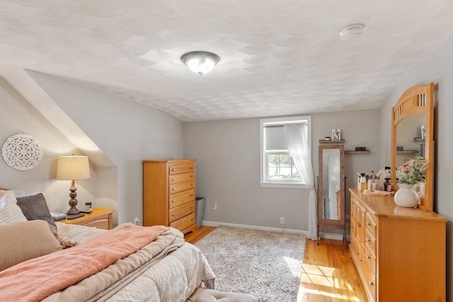 bedroom featuring light wood-style flooring and baseboards