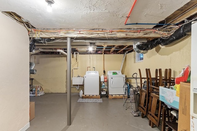 basement featuring a sink and washing machine and dryer