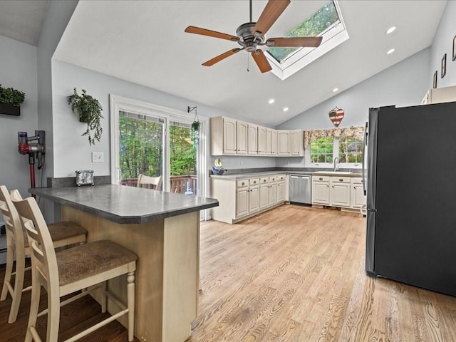 235 Stone School Rd, Sutton, MA 01590 - kitchen featuring appliances with stainless steel finishes, a peninsula, ceiling fan, a breakfast bar area, and a skylight