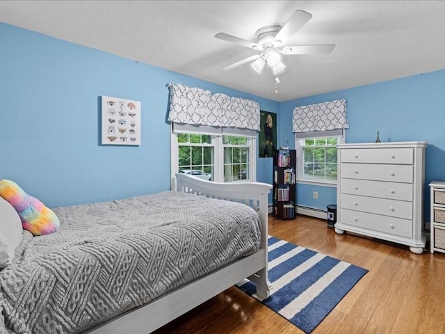235 Stone School Rd, Sutton, MA 01590 - bedroom featuring a baseboard heating unit, wood finished floors, and ceiling fan
