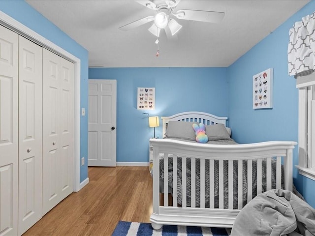 235 Stone School Rd, Sutton, MA 01590 - bedroom featuring wood finished floors, a closet, baseboards, and a ceiling fan