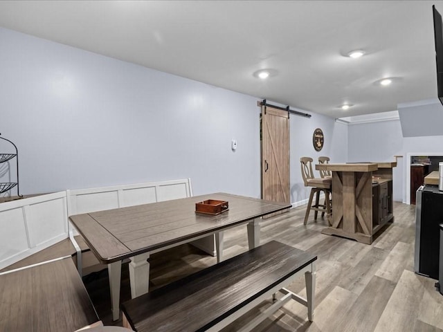235 Stone School Rd, Sutton, MA 01590 - dining room featuring a barn door and light wood-style flooring