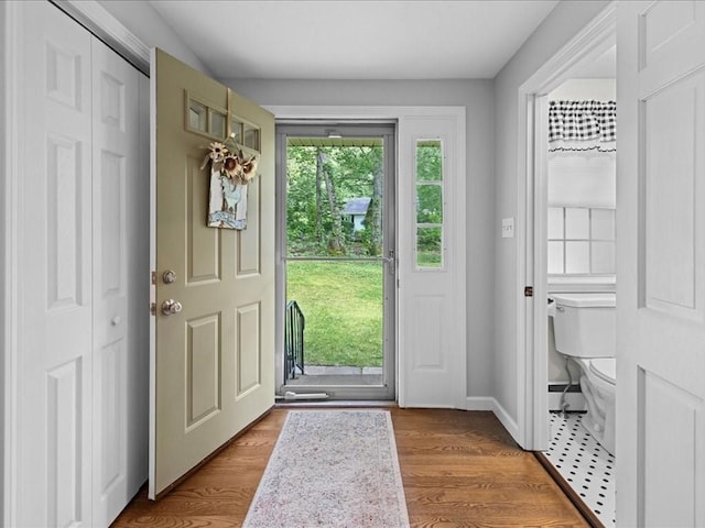 235 Stone School Rd, Sutton, MA 01590 - foyer with wood finished floors, baseboards, and a baseboard radiator