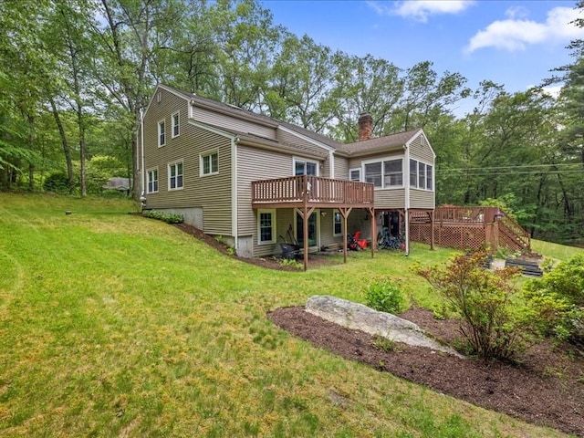 235 Stone School Rd, Sutton, MA 01590 - back of property featuring a wooden deck, a sunroom, a chimney, and a lawn