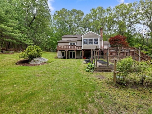 235 Stone School Rd, Sutton, MA 01590 - rear view of property with a wooden deck, a chimney, and a lawn