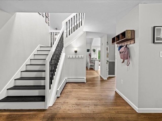 235 Stone School Rd, Sutton, MA 01590 - stairway featuring baseboards, wood finished floors, and baseboard heating