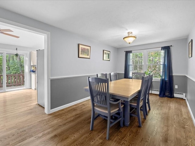 235 Stone School Rd, Sutton, MA 01590 - dining room with wood finished floors, a ceiling fan, a baseboard radiator, and baseboards