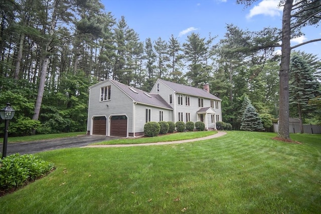 24 Fairhaven Cir, Sudbury, MA 01776 - colonial house featuring driveway, an attached garage, a chimney, and a front yard