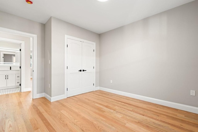 19 Vine Unit 4, Weymouth, MA 02188 - unfurnished bedroom featuring light wood-style flooring, baseboards, and a closet
