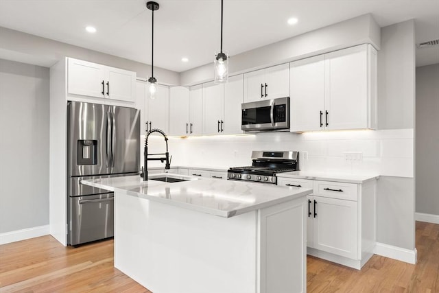 19 Vine Unit 4, Weymouth, MA 02188 - kitchen featuring appliances with stainless steel finishes, a sink, decorative backsplash, baseboards, and white cabinets