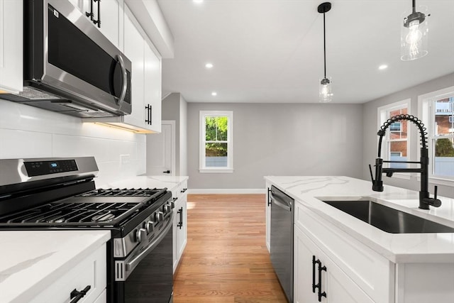 19 Vine Unit 4, Weymouth, MA 02188 - kitchen with appliances with stainless steel finishes, a sink, recessed lighting, light wood-style floors, and baseboards