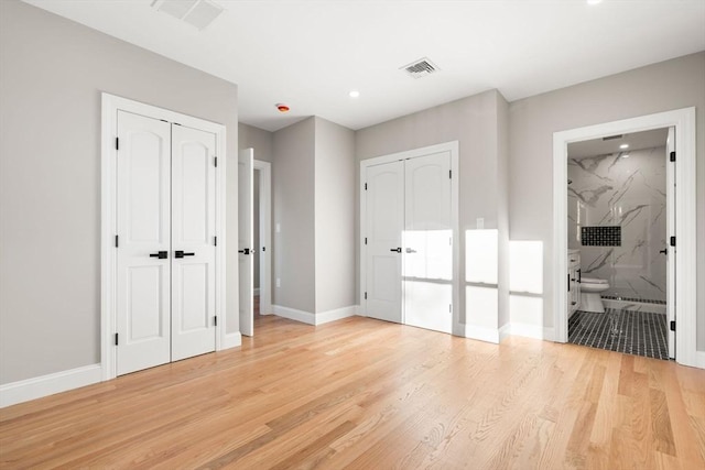 19 Vine Unit 4, Weymouth, MA 02188 - unfurnished bedroom featuring two closets, light wood-type flooring, baseboards, recessed lighting, and ensuite bath