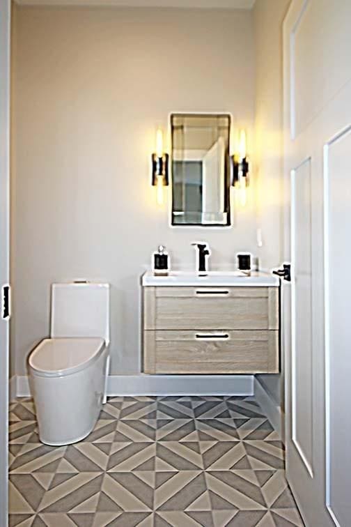 bathroom with tile patterned flooring, vanity, and toilet