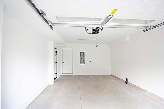 garage with a garage door opener and electric panel