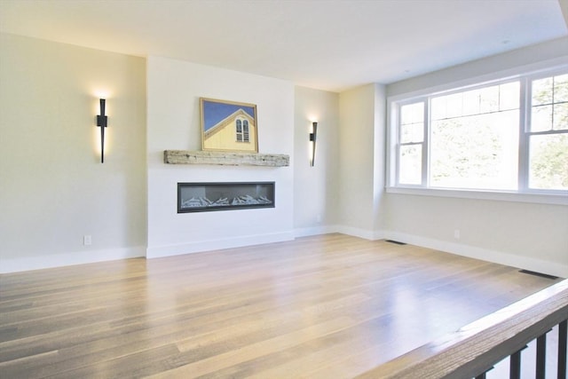 unfurnished living room featuring wood-type flooring