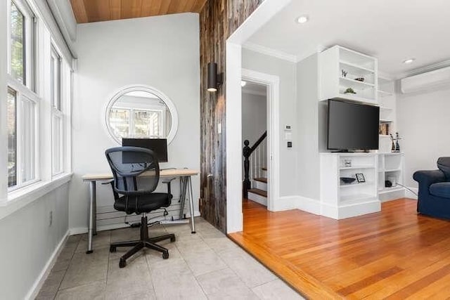 office with light tile patterned floors, baseboards, crown molding, and a wall unit AC