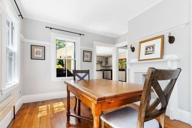 dining area with baseboards and light wood-type flooring