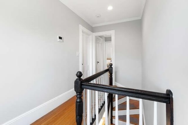 stairs with baseboards, ornamental molding, recessed lighting, and wood finished floors