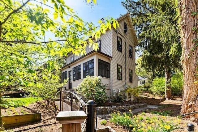 view of side of home with a garden