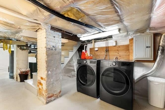 clothes washing area with electric panel, laundry area, and washer and dryer