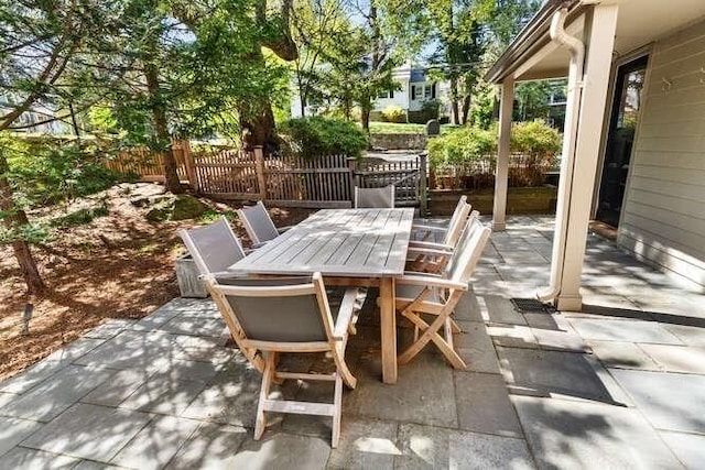view of patio / terrace featuring fence and outdoor dining area