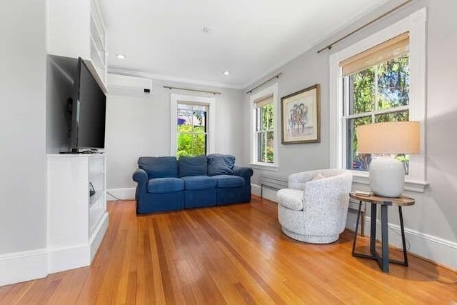 sitting room featuring baseboards, recessed lighting, and light wood-style flooring