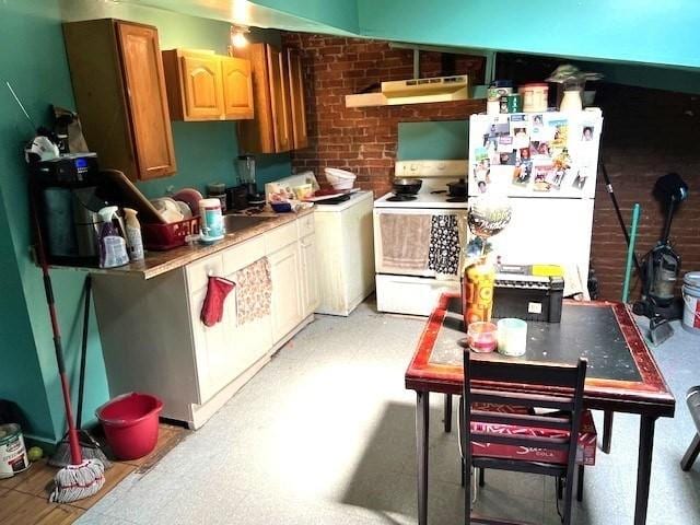 40 Byers St, Springfield, MA 01105 - kitchen featuring white appliances, under cabinet range hood, brick wall, light countertops, and light flooring