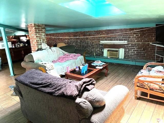 40 Byers St, Springfield, MA 01105 - living area featuring brick wall and wood finished floors