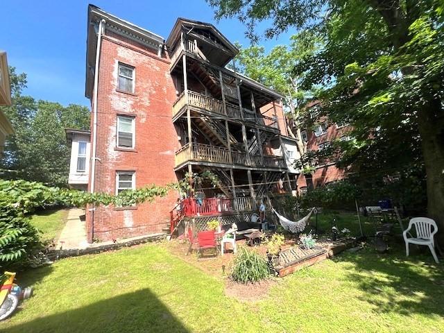 40 Byers St, Springfield, MA 01105 - rear view of property with brick siding and a yard