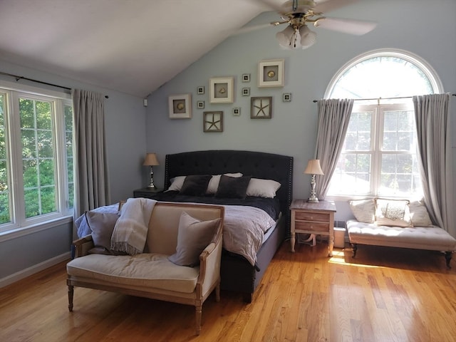 bedroom featuring ceiling fan, light wood-type flooring, and vaulted ceiling