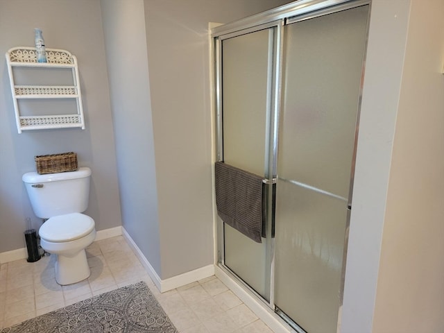 bathroom with a shower with door, tile patterned flooring, and toilet