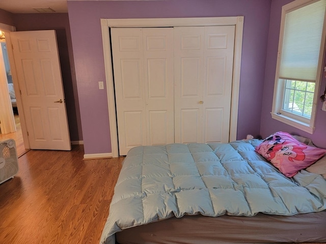 bedroom featuring a closet and light wood-type flooring