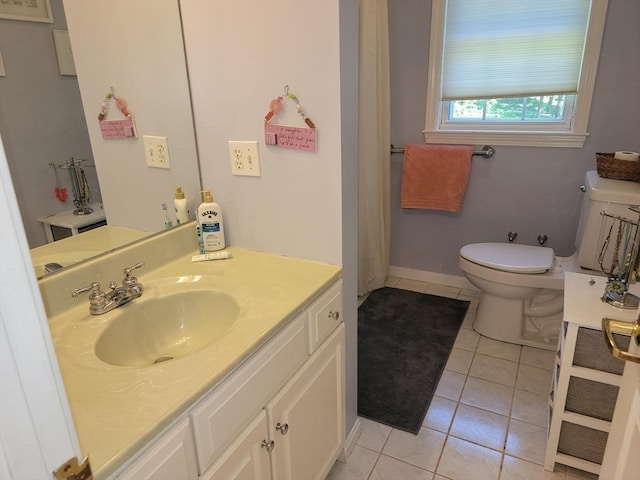 bathroom featuring toilet, vanity, and tile patterned floors