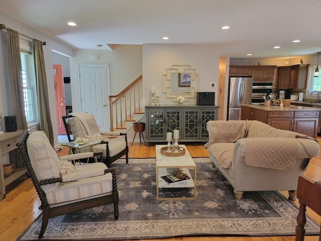 living room with sink and light hardwood / wood-style flooring